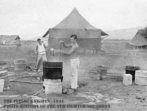 Boiling water in large drums to wash clothes